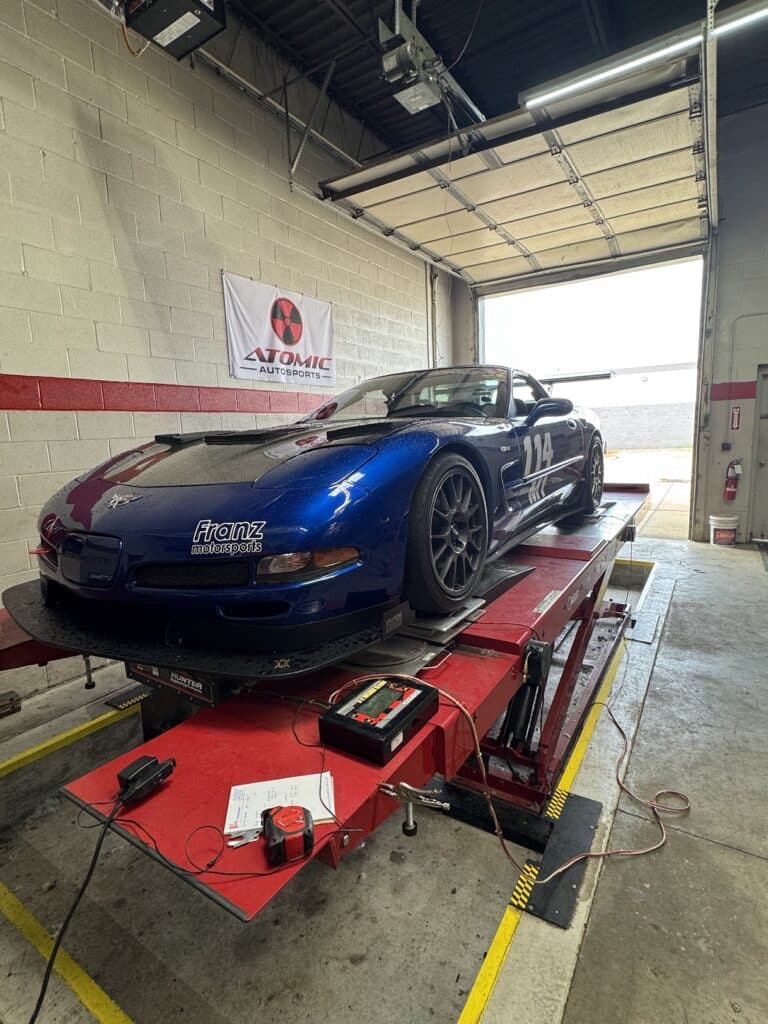 2003 Chevrolet Corvette Z06 on the lift for alignment and corner balancing at Atomic Autosports.