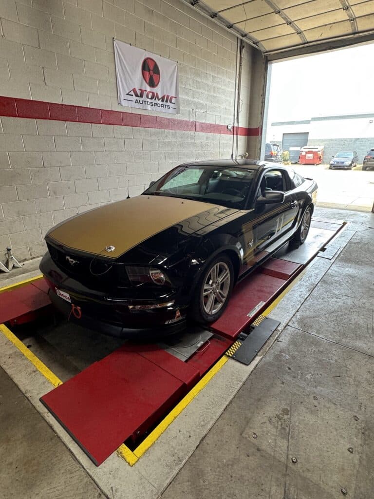 2009 Ford Mustang GT undergoing full track prep and maintenance at Atomic Autosports.
