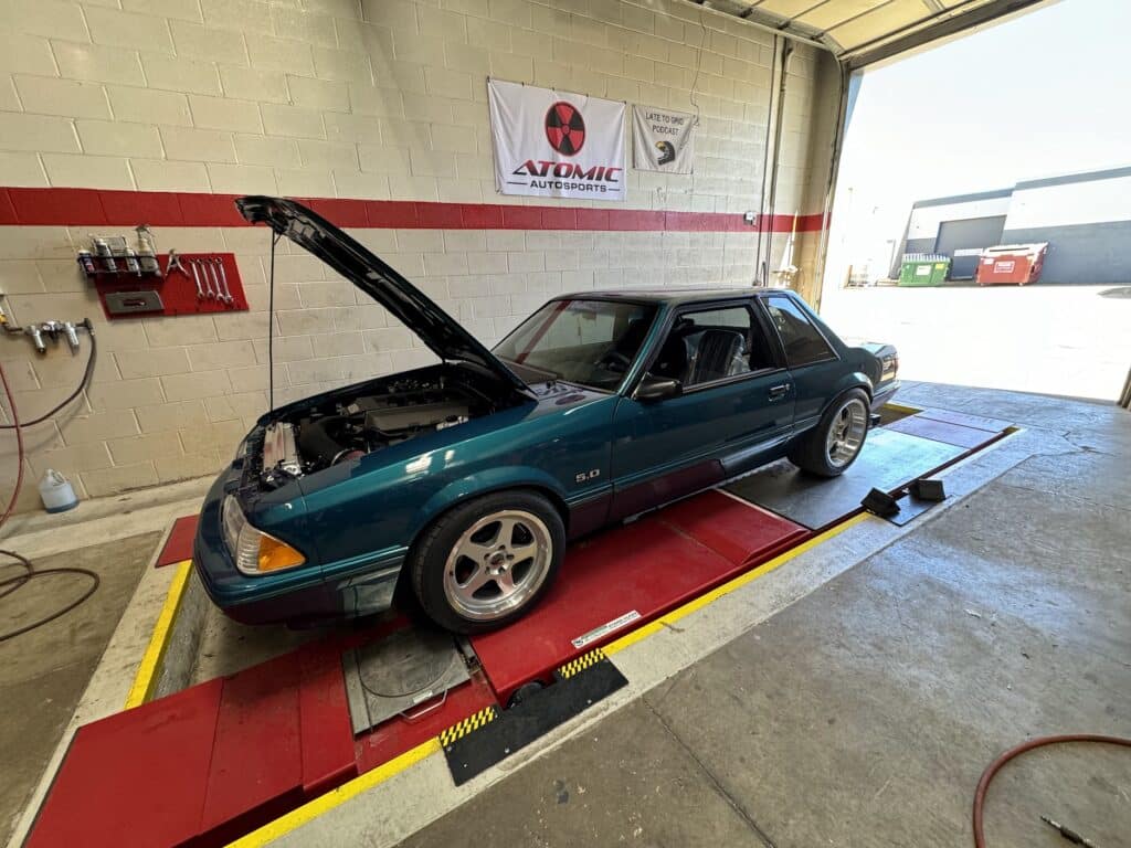 1993 Ford Mustang GT receiving alignment service at Atomic Autosports.