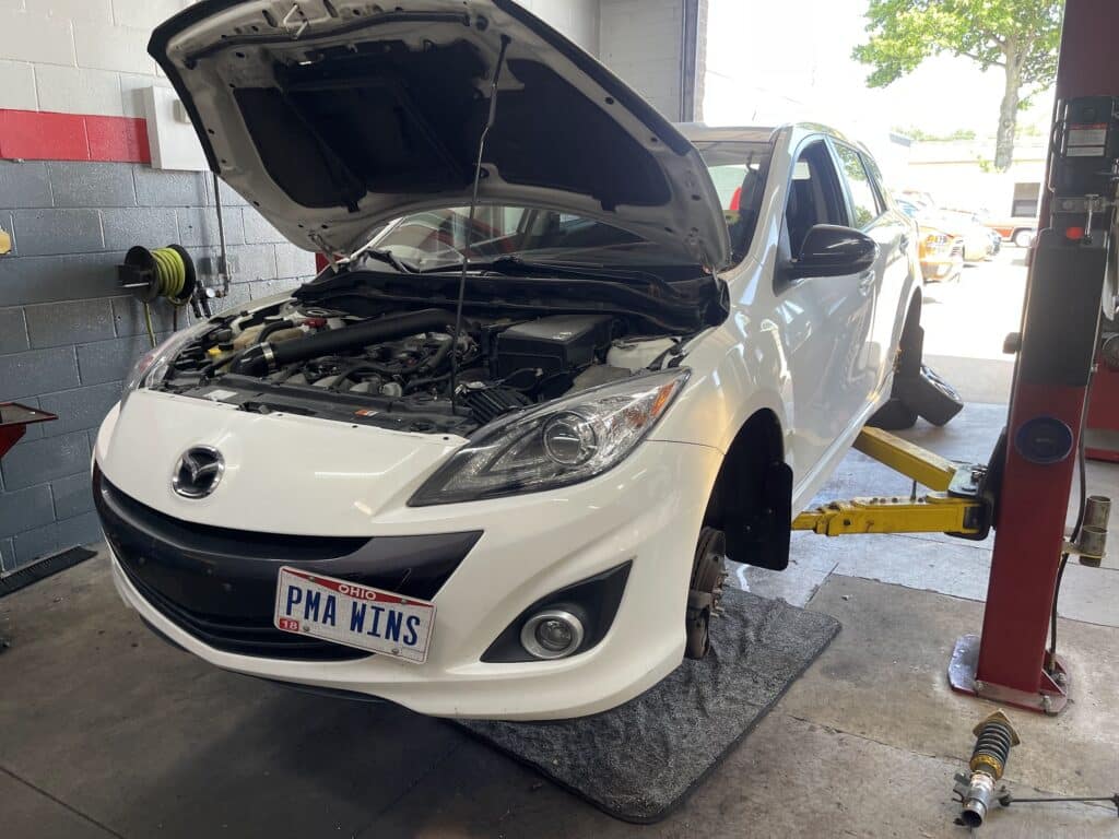 2013 Mazdaspeed3 with coilovers, new wheels, and suspension upgrades at Atomic Autosports.