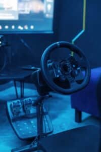 Close up view of driving simulator steering wheel and pedals.