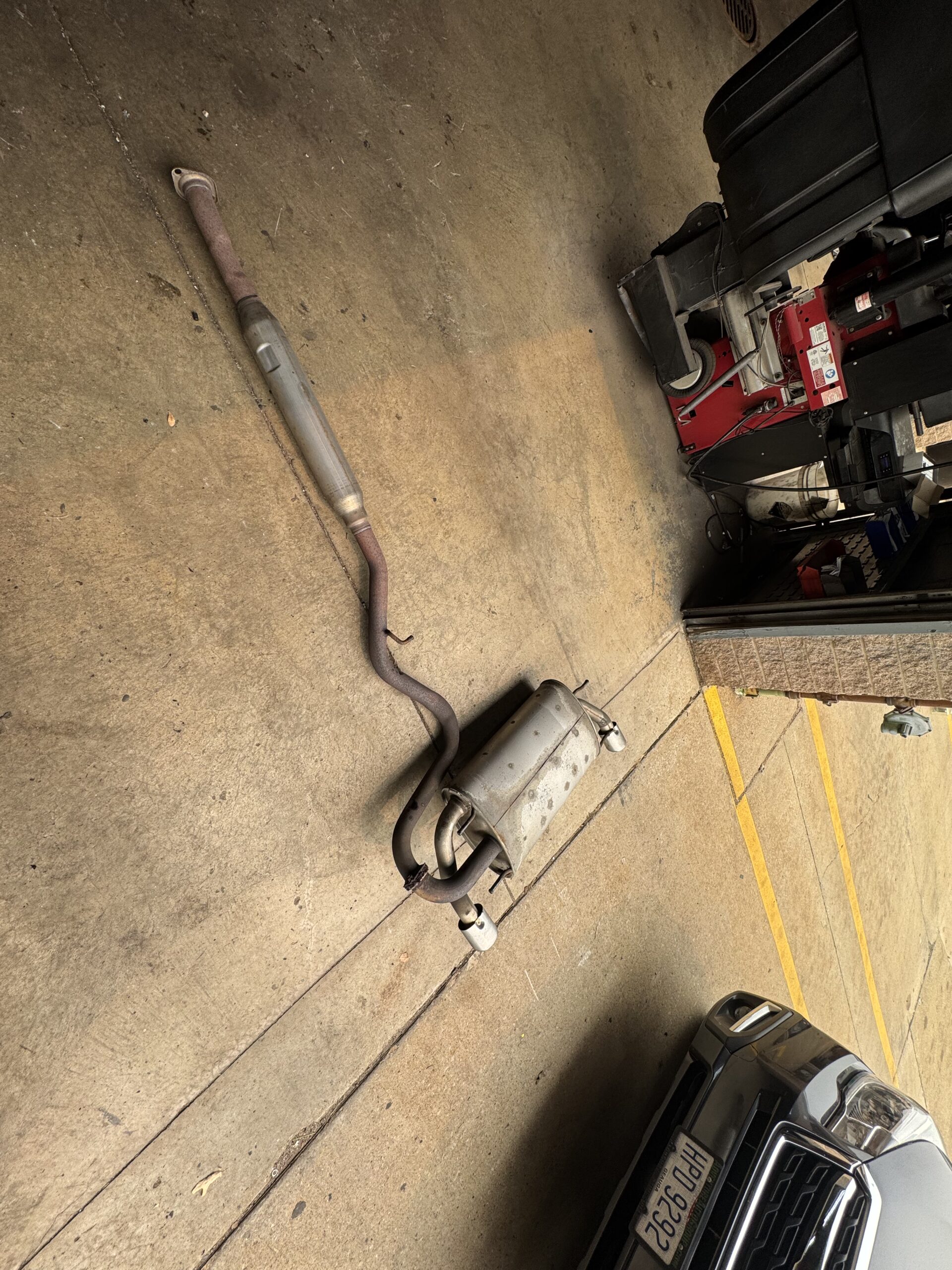Factory cat-back exhaust removed from a 2013 Scion FR-S at Atomic Autosports
