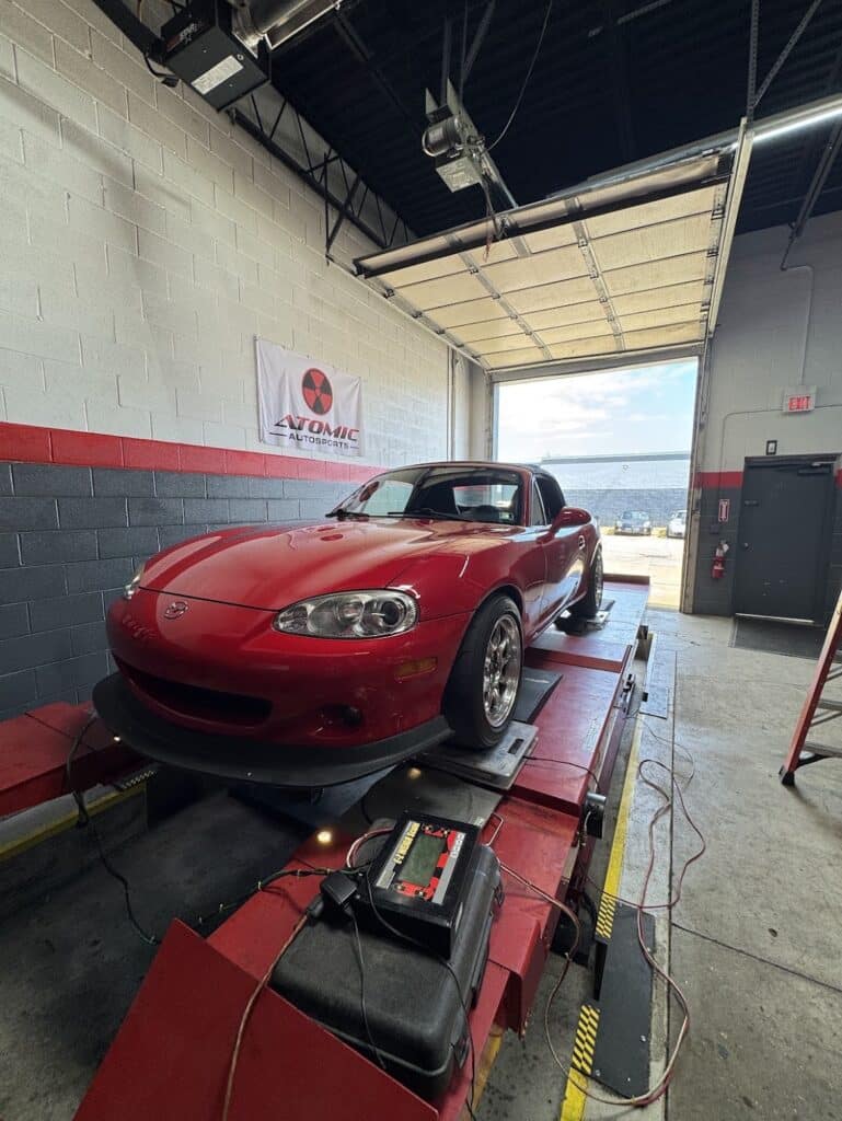2004 Mazda Miata receiving a custom alignment and corner balance at Atomic Autosports.